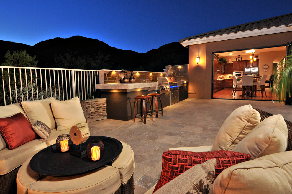 Example of a transitional backyard stone patio kitchen design in Phoenix