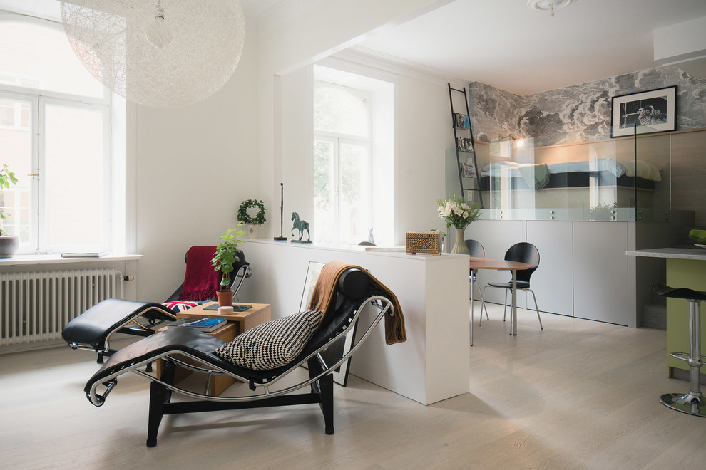Photo of a small contemporary open concept living room in Stockholm with white walls.