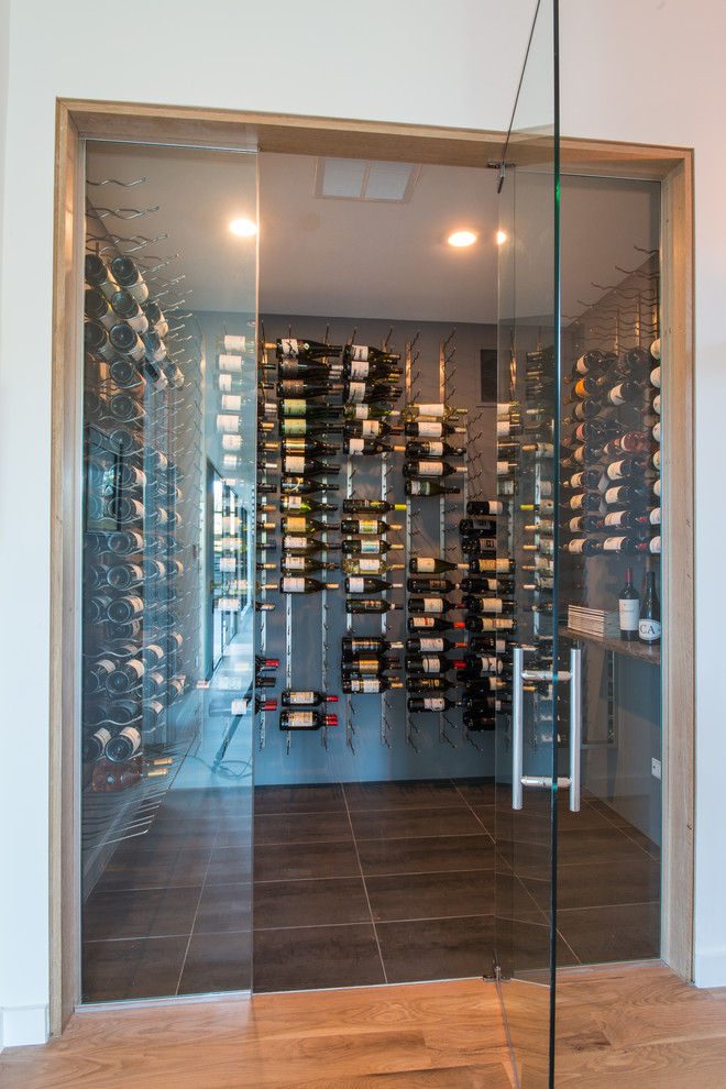 Large contemporary wine cellar in Dallas with storage racks.