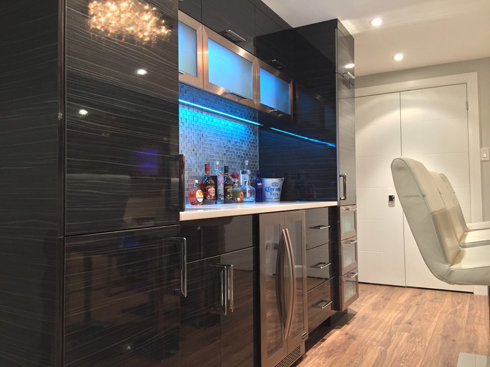 Mid-sized modern single-wall home bar in Montreal with an undermount sink, flat-panel cabinets, grey cabinets, quartz benchtops, grey splashback, glass tile splashback and vinyl floors.