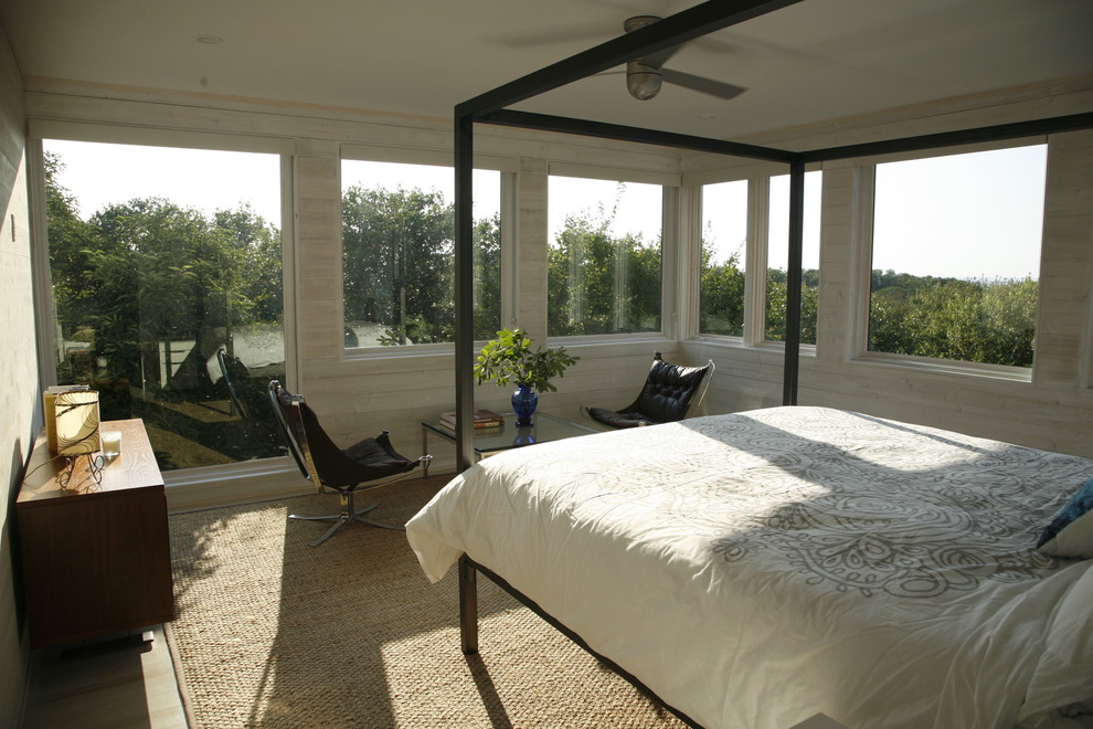 Photo of a beach style bedroom in New York with beige walls.