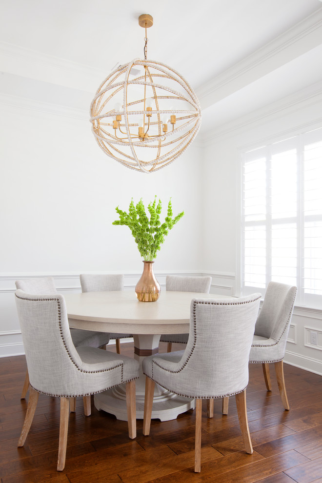 Photo of a traditional dining room in Charleston with white walls and medium hardwood floors.