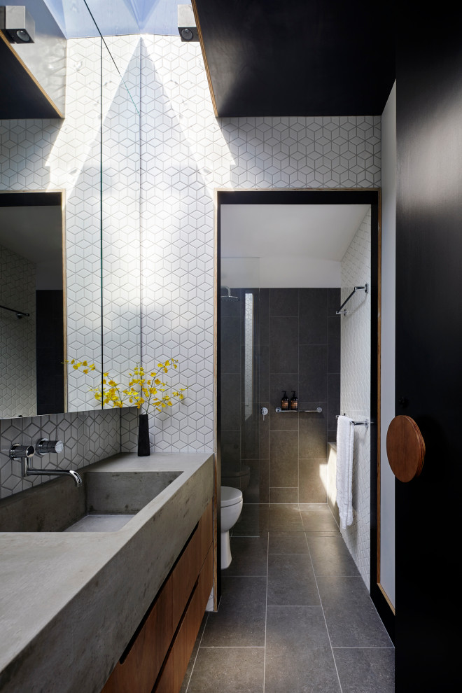 This is an example of a mid-sized modern master bathroom in Melbourne with medium wood cabinets, a drop-in tub, a one-piece toilet, white tile, mosaic tile, white walls, an undermount sink, concrete benchtops, grey floor, grey benchtops, a single vanity, a built-in vanity, recessed and decorative wall panelling.