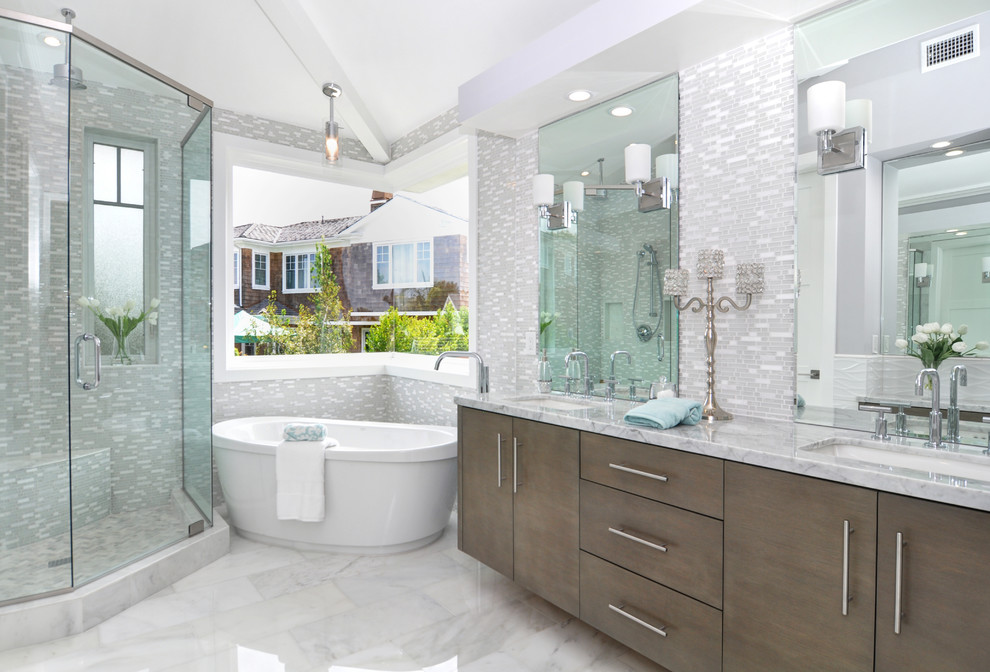 Transitional master gray tile and mosaic tile marble floor and white floor freestanding bathtub photo in Los Angeles with flat-panel cabinets, dark wood cabinets and an undermount sink