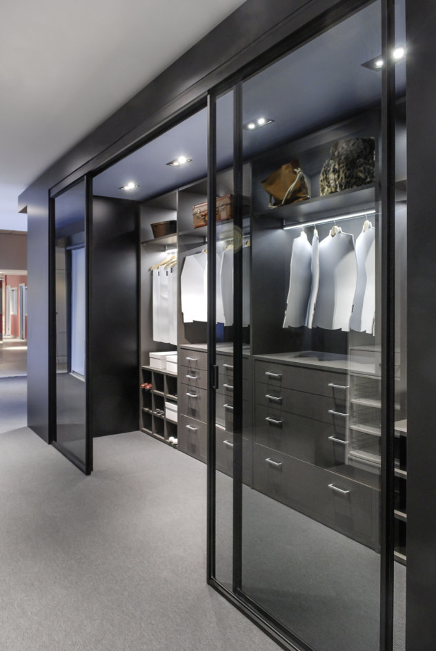 This is an example of a large contemporary gender-neutral walk-in wardrobe in Moscow with laminate floors and grey floor.