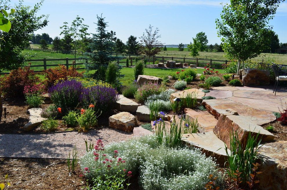 Design ideas for a large traditional backyard full sun garden in Other with a garden path and natural stone pavers.