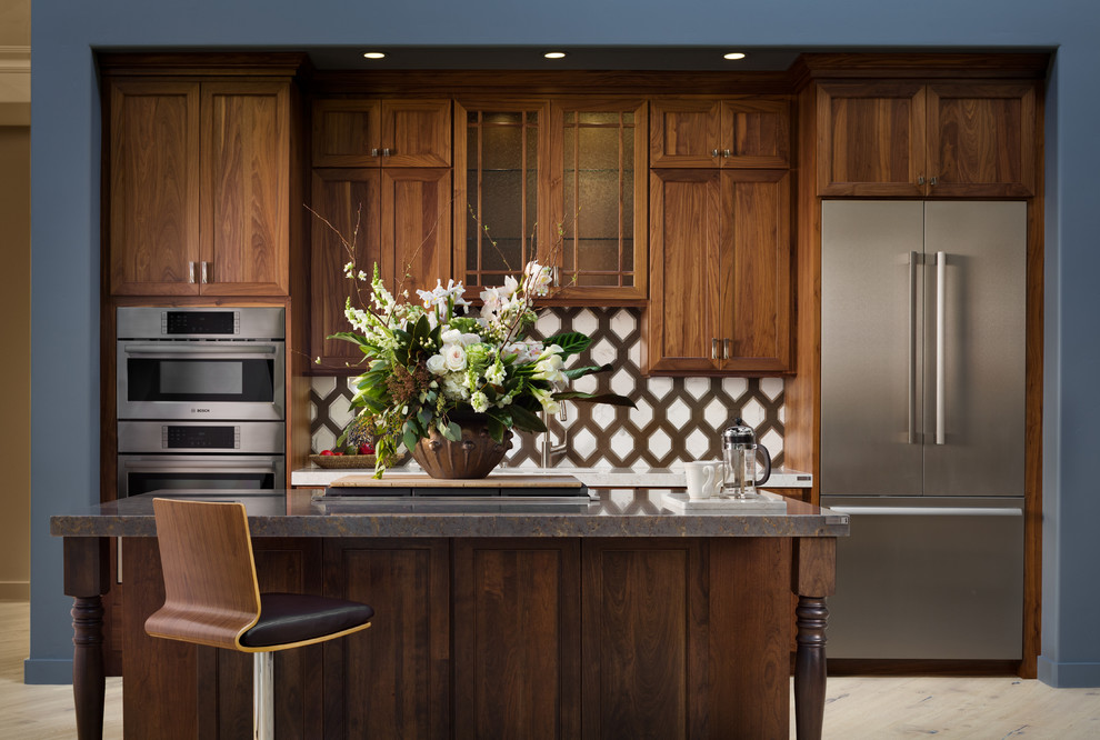 Inspiration for a mid-sized transitional galley light wood floor and beige floor eat-in kitchen remodel in San Francisco with a double-bowl sink, dark wood cabinets, quartzite countertops, white backsplash, ceramic backsplash, stainless steel appliances and an island
