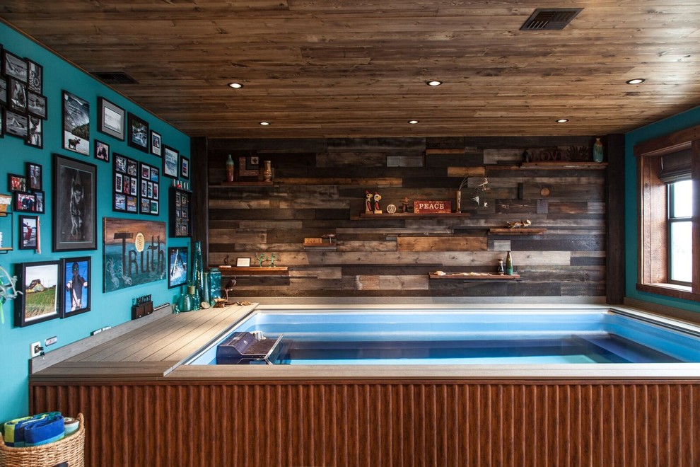 Example of a small mountain style indoor rectangular lap pool design with decking