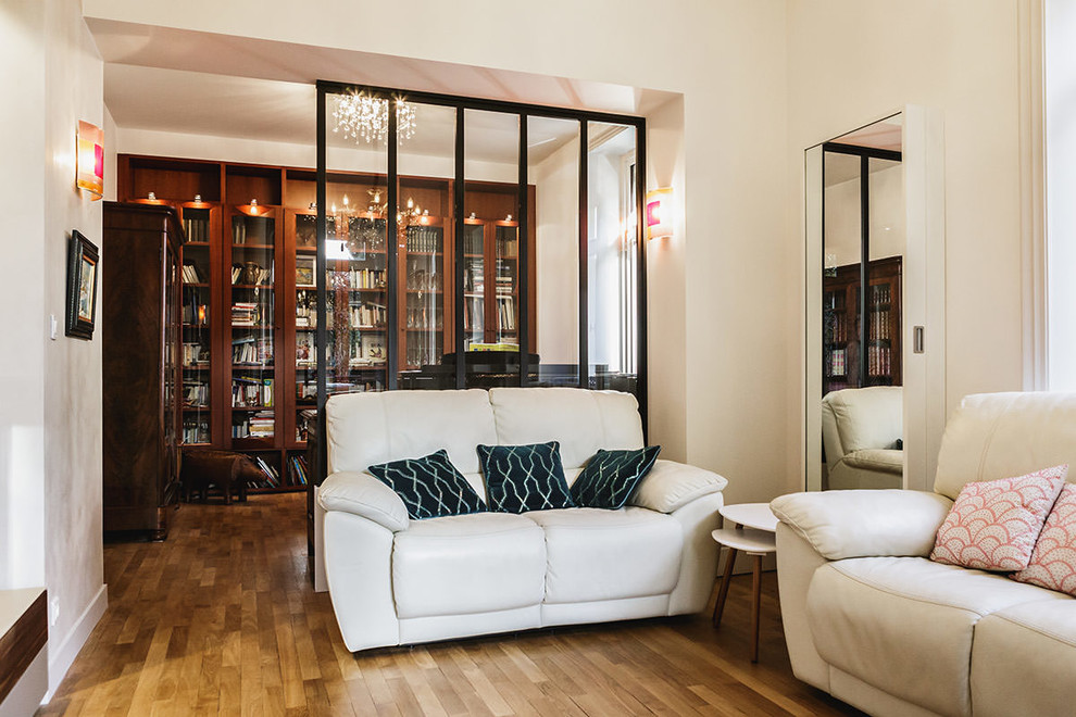 Idée de décoration pour un salon minimaliste de taille moyenne et ouvert avec une bibliothèque ou un coin lecture, un mur blanc, parquet clair, un sol beige et un téléviseur indépendant.