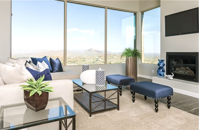 Example of a mid-sized transitional open concept medium tone wood floor living room design in Phoenix with a wall-mounted tv, gray walls and a standard fireplace