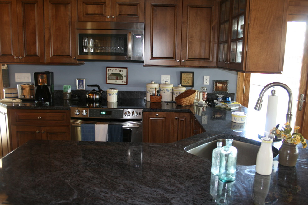 Large mountain style u-shaped eat-in kitchen photo in Boston with an undermount sink, raised-panel cabinets, medium tone wood cabinets, stainless steel appliances, a peninsula and granite countertops