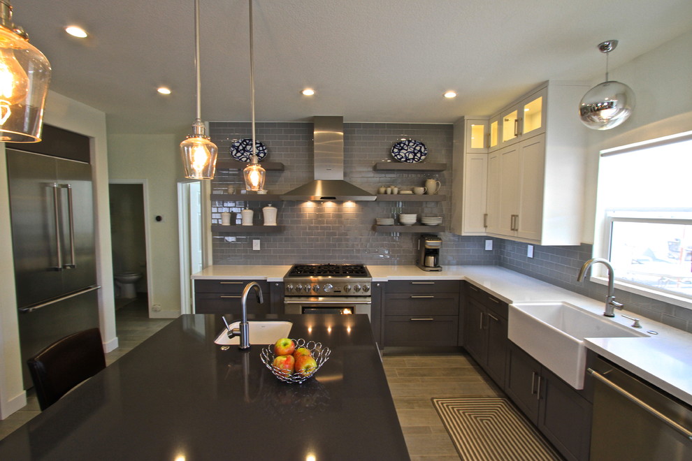 Kitchen - transitional porcelain tile kitchen idea in Orange County with glass tile backsplash and an island