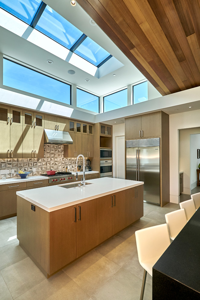 Photo of a contemporary l-shaped kitchen in San Francisco with an undermount sink, flat-panel cabinets, medium wood cabinets, multi-coloured splashback, stainless steel appliances and with island.