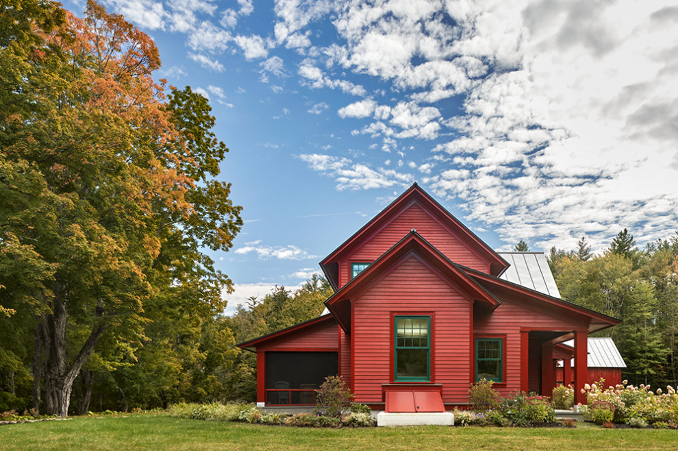 Farmhouse red wood and clapboard exterior home photo in Boston with a metal roof
