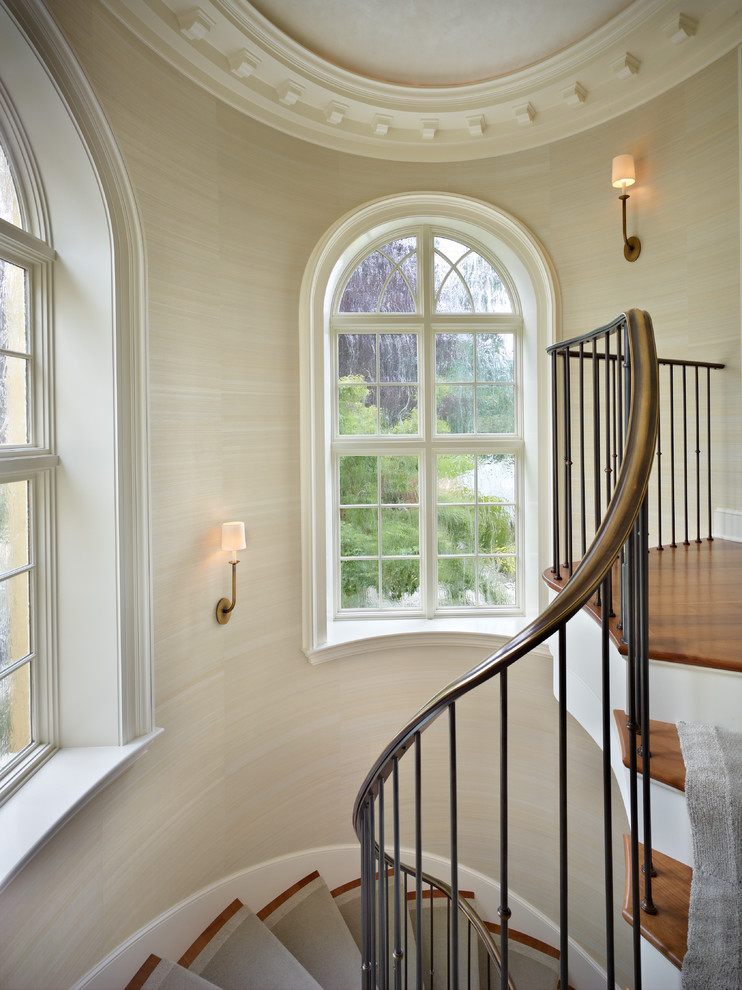 Photo of a traditional wood curved staircase in Seattle.