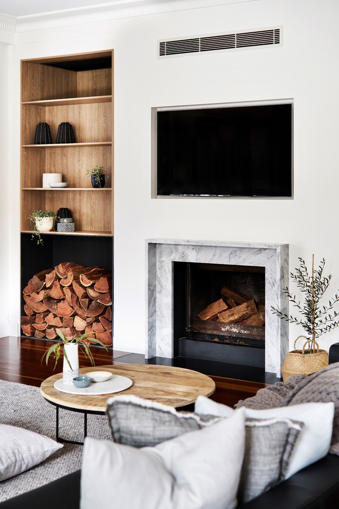 This is an example of a large scandinavian formal open concept living room in Sydney with white walls, dark hardwood floors, a standard fireplace, a stone fireplace surround, a wall-mounted tv and brown floor.