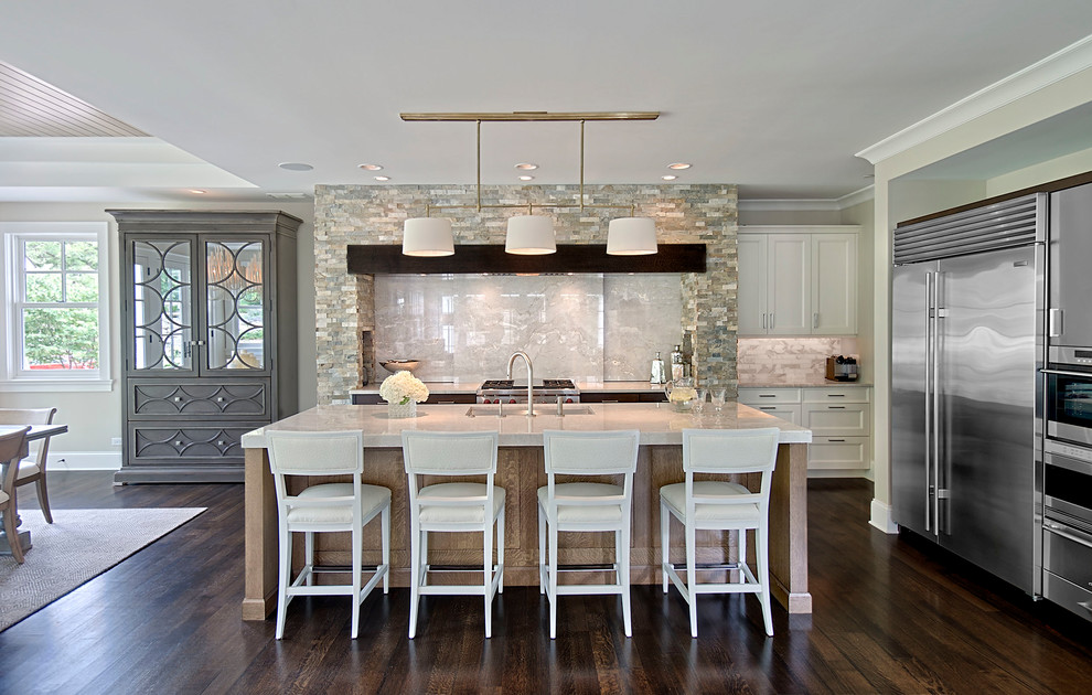 Mid-sized transitional l-shaped dark wood floor and brown floor open concept kitchen photo in Chicago with an undermount sink, recessed-panel cabinets, white cabinets, quartz countertops, gray backsplash, porcelain backsplash, stainless steel appliances and an island