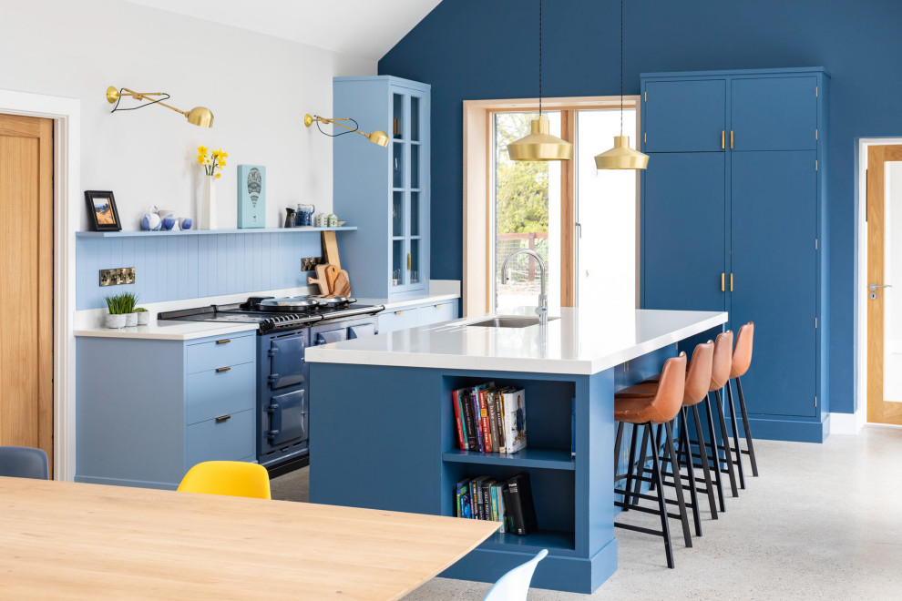 Inspiration for a large country u-shaped kitchen in Other with a drop-in sink, recessed-panel cabinets, blue cabinets, marble benchtops, blue splashback, cement tiles, with island, grey floor and white benchtop.