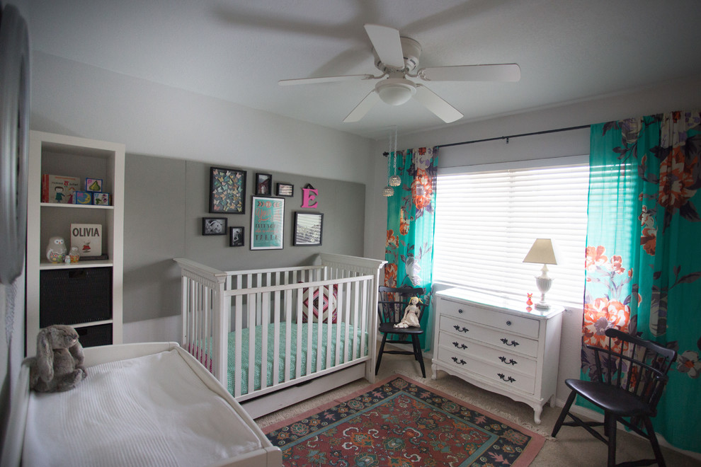 This is an example of a small eclectic nursery for girls in San Diego with grey walls and carpet.