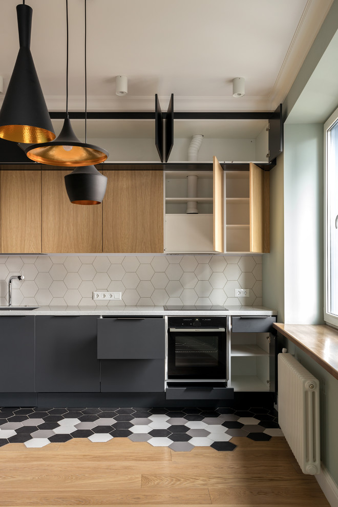 This is an example of a mid-sized scandinavian kitchen in Moscow.