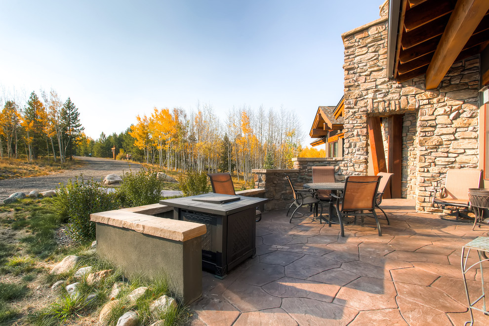 Contemporary patio in Denver with natural stone pavers and no cover.