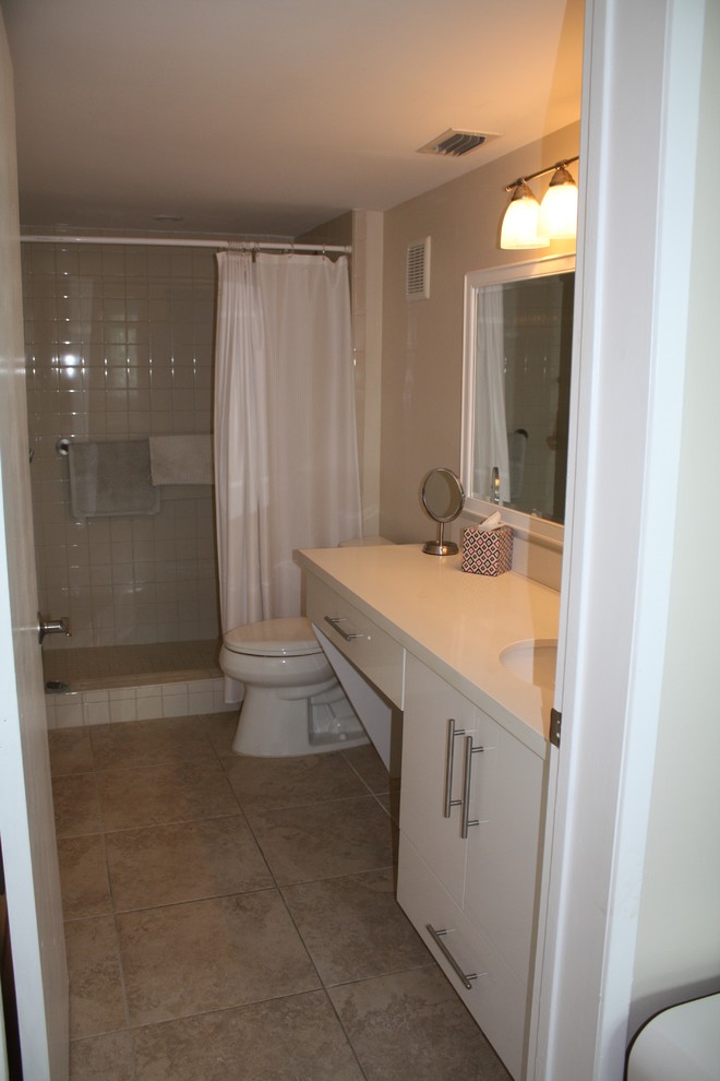 Design ideas for a small contemporary 3/4 bathroom in Miami with flat-panel cabinets, white cabinets, a one-piece toilet, white tile, ceramic tile, beige walls, ceramic floors, an undermount sink, engineered quartz benchtops, beige floor, a shower curtain, white benchtops and an alcove shower.