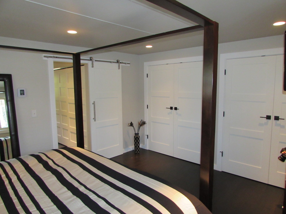 Photo of a mid-sized modern master bedroom in Seattle with grey walls and dark hardwood floors.