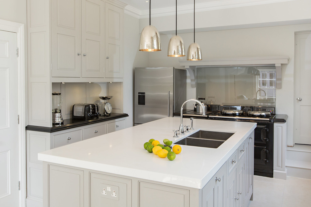 Inspiration for a mid-sized transitional u-shaped kitchen in Other with a double-bowl sink, recessed-panel cabinets, grey cabinets, glass sheet splashback, stainless steel appliances and with island.