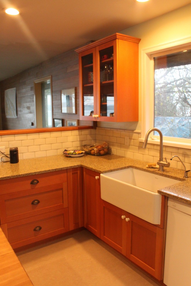This is an example of a small arts and crafts u-shaped separate kitchen in Vancouver with a farmhouse sink, recessed-panel cabinets, medium wood cabinets, granite benchtops, white splashback, ceramic splashback, stainless steel appliances and with island.