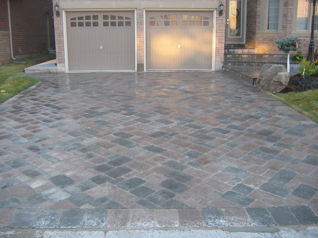 Transitional front yard brick garage photo in Toronto