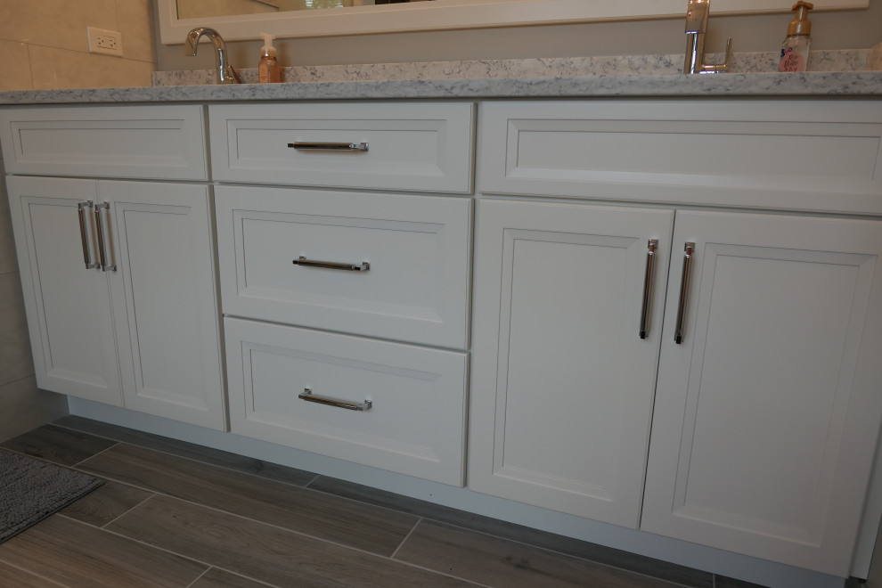Double-sink bathroom photo in Chicago with white cabinets and a built-in vanity