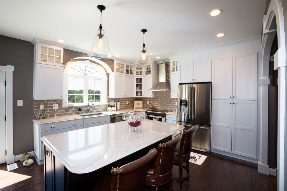 Inspiration for a traditional l-shaped eat-in kitchen in Baltimore with a drop-in sink, shaker cabinets, white cabinets, granite benchtops, green splashback, ceramic splashback, stainless steel appliances, dark hardwood floors and with island.