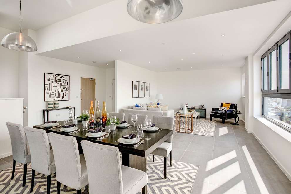 Photo of a contemporary open plan dining in London with white walls.
