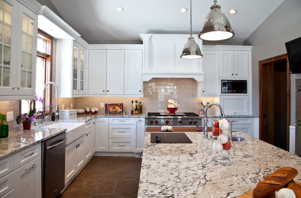 Open concept kitchen - large transitional u-shaped slate floor and brown floor open concept kitchen idea with a farmhouse sink, shaker cabinets, white cabinets, granite countertops, yellow backsplash, subway tile backsplash, stainless steel appliances and two islands