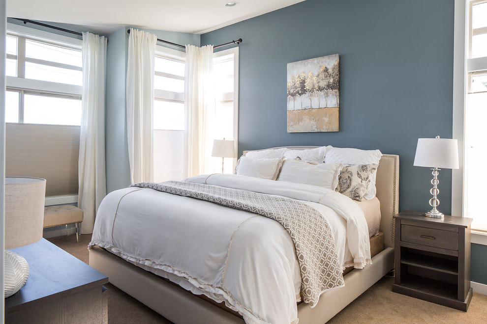 Photo of a transitional master bedroom in Seattle with blue walls.