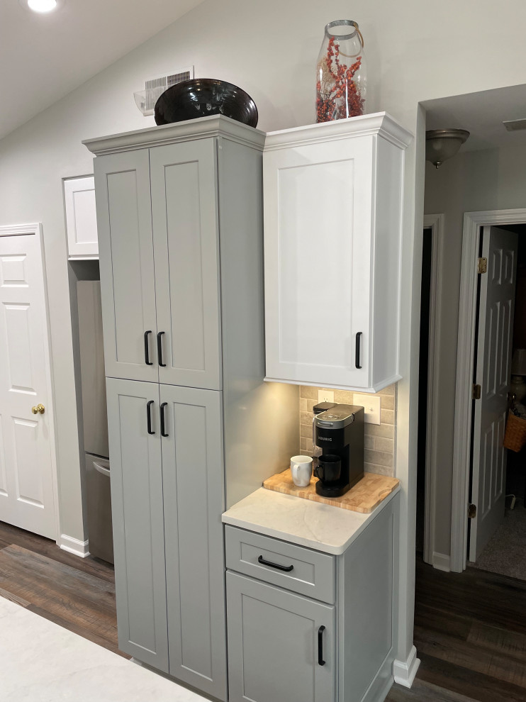 Inspiration for a small transitional single-wall vinyl floor and brown floor kitchen pantry remodel with shaker cabinets, gray cabinets, quartz countertops, gray backsplash, subway tile backsplash, no island and white countertops