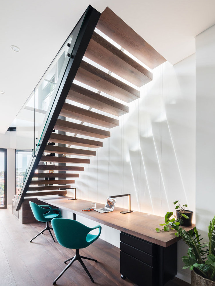 Mid-sized contemporary wood floating staircase in Sydney with wood risers and glass railing.