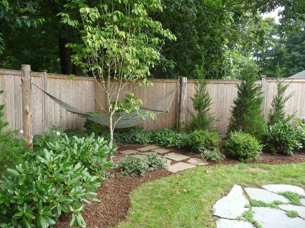 This is an example of a beach style backyard partial sun garden for summer in Bridgeport with natural stone pavers.