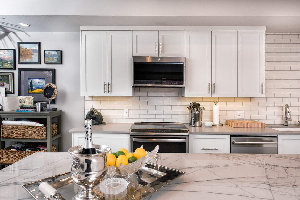 Mid-sized transitional l-shaped eat-in kitchen photo with flat-panel cabinets, white cabinets and an island