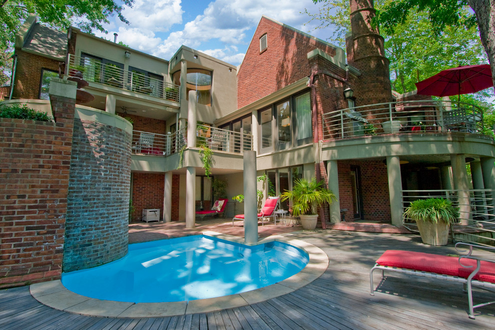 Photo of a contemporary pool in Little Rock with brick pavers.
