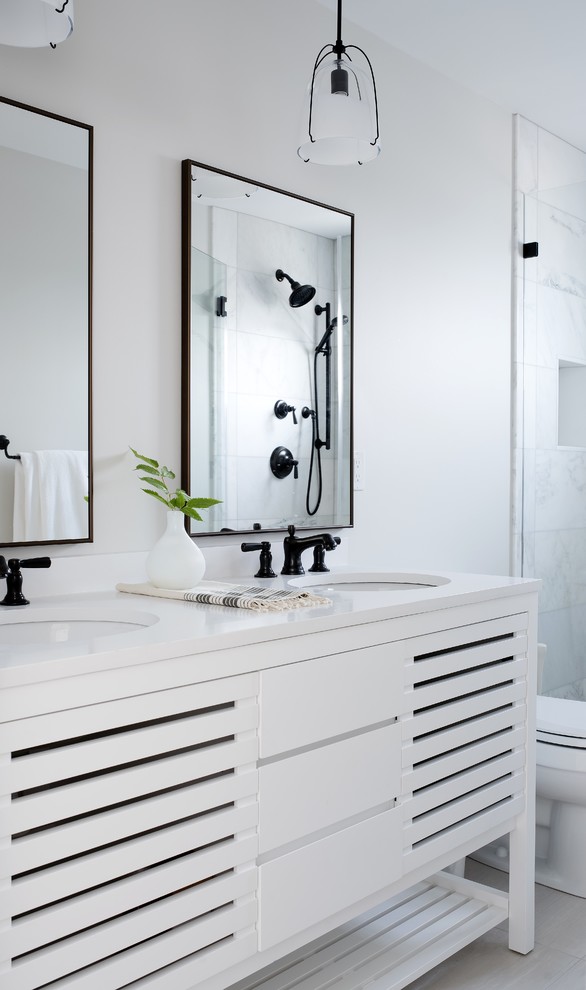 Design ideas for a contemporary bathroom in Portland Maine with louvered cabinets, white cabinets, white tile, white walls, an undermount sink, white floor, a hinged shower door and white benchtops.
