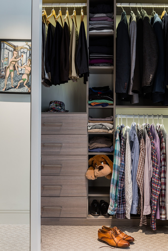 This is an example of a contemporary men's walk-in wardrobe in Boston with flat-panel cabinets, grey cabinets and carpet.