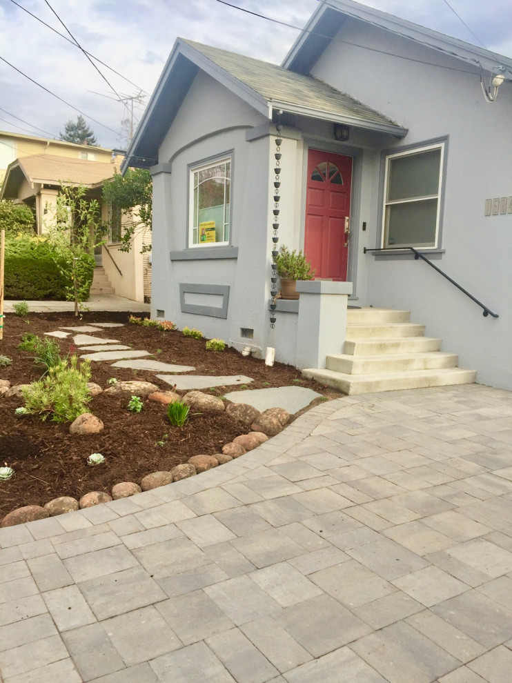 Mid-sized contemporary front yard partial sun driveway in San Francisco with with a gate, brick pavers and a wood fence for summer.