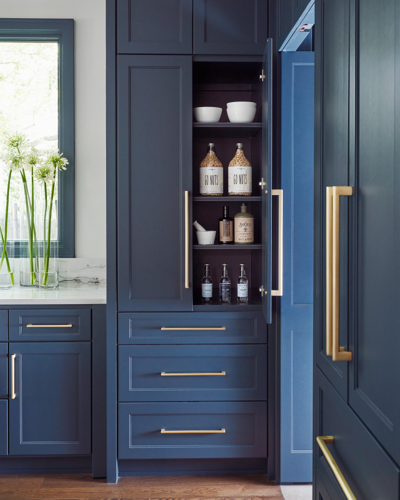 Large transitional l-shaped medium tone wood floor and brown floor open concept kitchen photo in Other with a farmhouse sink, recessed-panel cabinets, blue cabinets, quartzite countertops, white backsplash, stone slab backsplash, paneled appliances, an island and white countertops