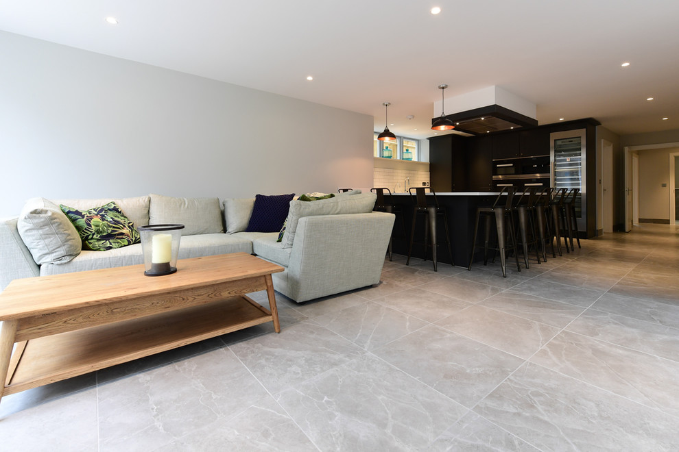 This is an example of a contemporary dining room in Oxfordshire with porcelain floors and grey floor.
