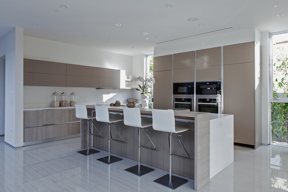 Design ideas for a small contemporary l-shaped separate kitchen in Los Angeles with flat-panel cabinets, beige cabinets, quartz benchtops, white splashback, stainless steel appliances, ceramic floors and with island.