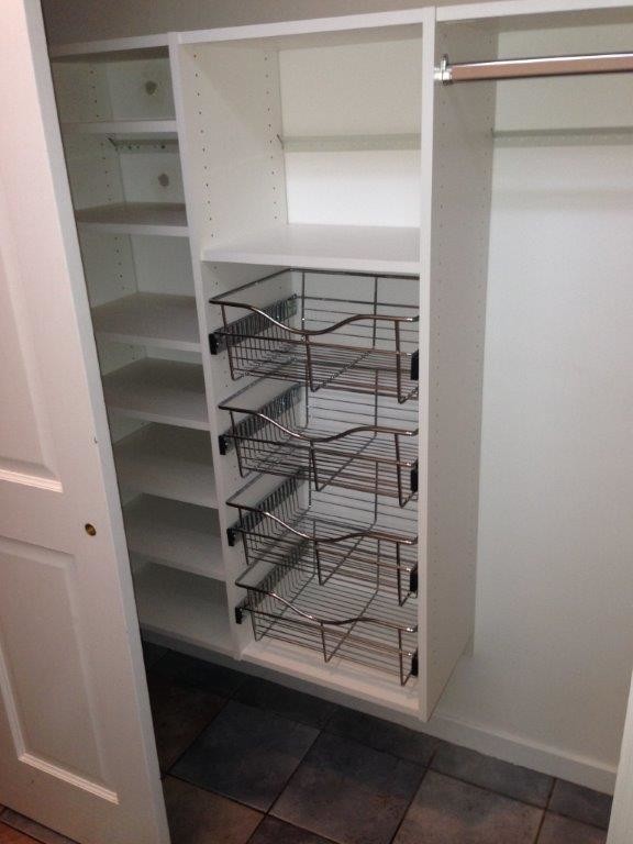 Photo of a mid-sized traditional built-in wardrobe in Minneapolis with open cabinets and white cabinets.