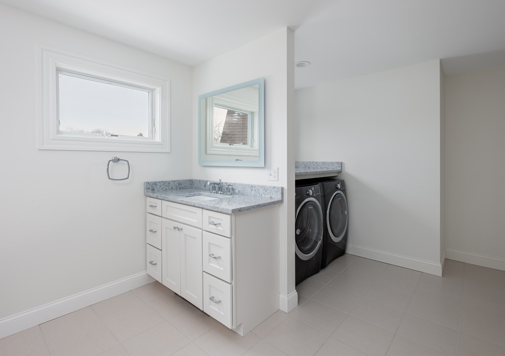 Expansive contemporary utility room in Portland Maine with an undermount sink, grey walls, ceramic floors and a side-by-side washer and dryer.