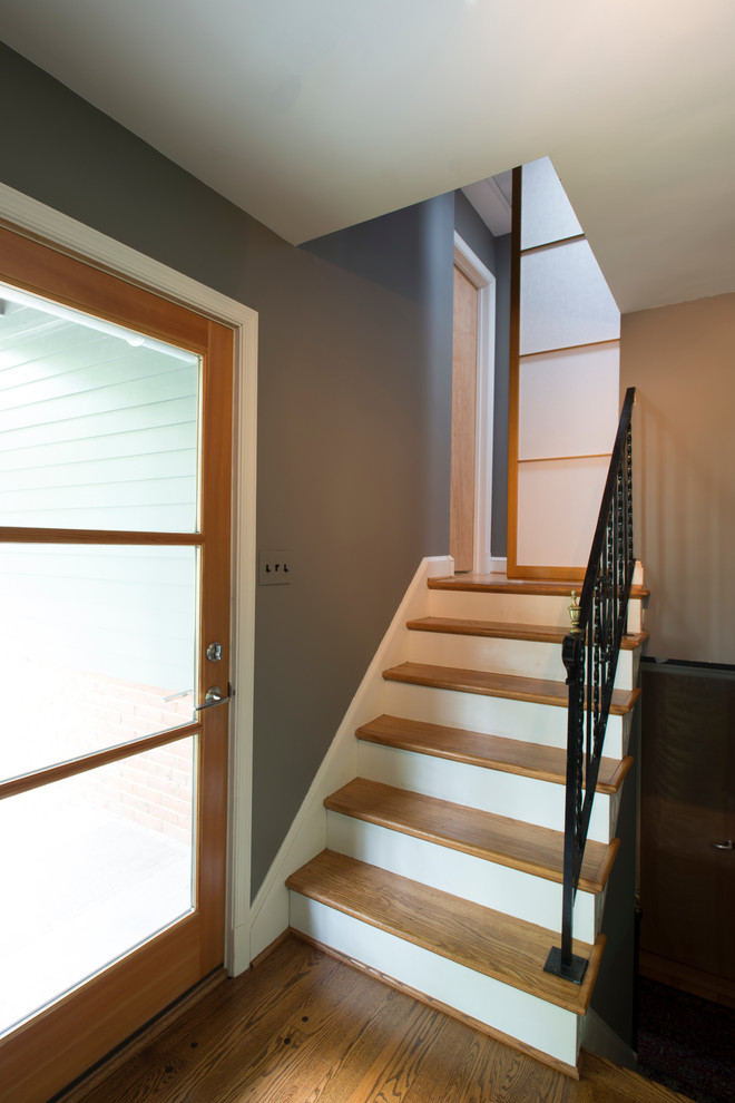 Foyer - small transitional medium tone wood floor foyer idea in DC Metro with gray walls and a glass front door