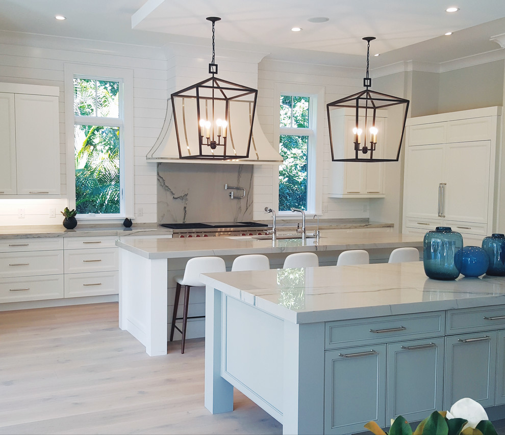 Inspiration for a transitional eat-in kitchen remodel in Miami with a double-bowl sink, shaker cabinets, white cabinets, stainless steel appliances, two islands and white countertops
